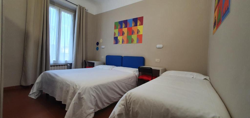 Łóżko lub łóżka w pokoju w obiekcie Hotel Genesi