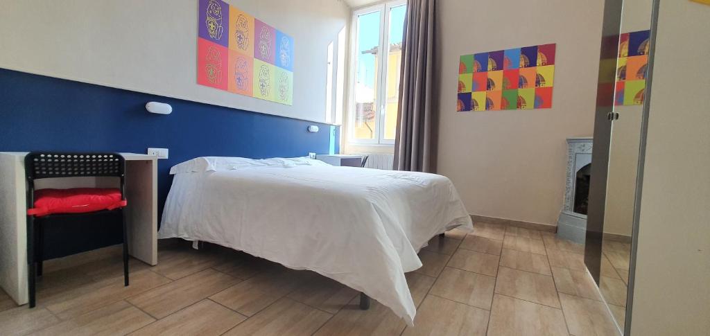um quarto com uma cama branca e uma parede azul em Hotel Genesi em Florença