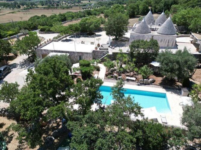 an aerial view of a resort with a swimming pool at Trulli holiday home with private pool near Ostuni in Ostuni