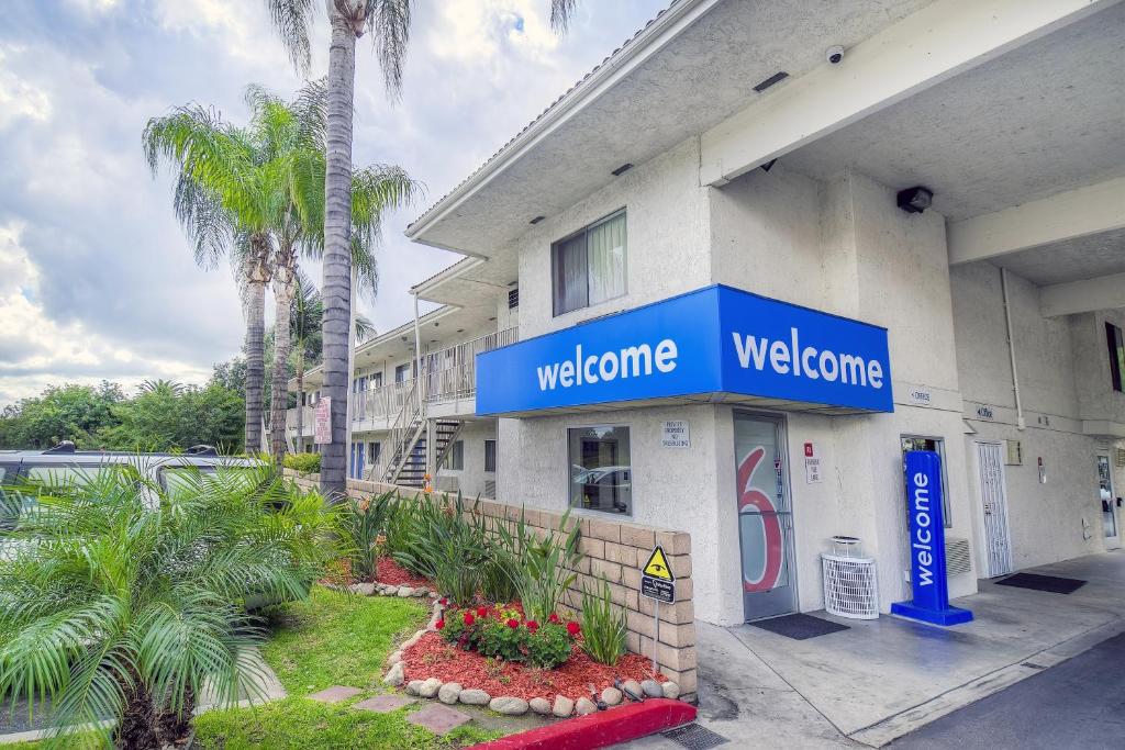a welcome sign on the side of a building at Motel 6 Chino, CA - Los Angeles Ontario in Chino