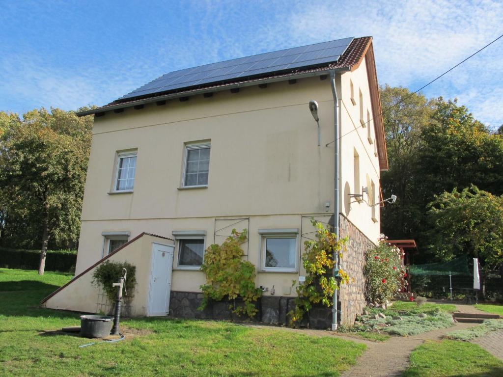 a house with a solar roof on top of it at Apartment Bismarcksberg by Interhome in Alt Schönau