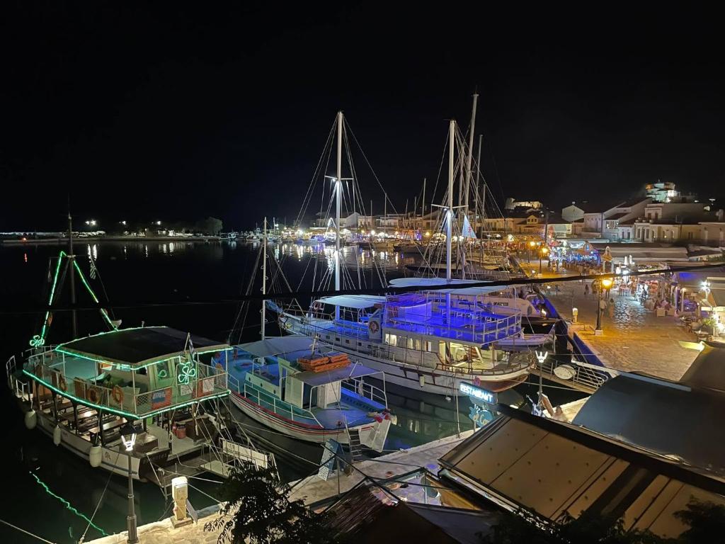 a group of boats docked at a dock at night at Aegean Blu Port House Pythagoreio in Pythagoreio