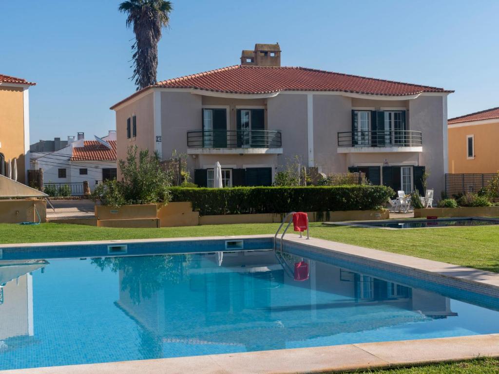 a villa with a swimming pool in front of a house at Holiday Home Girassol by Interhome in Cascais