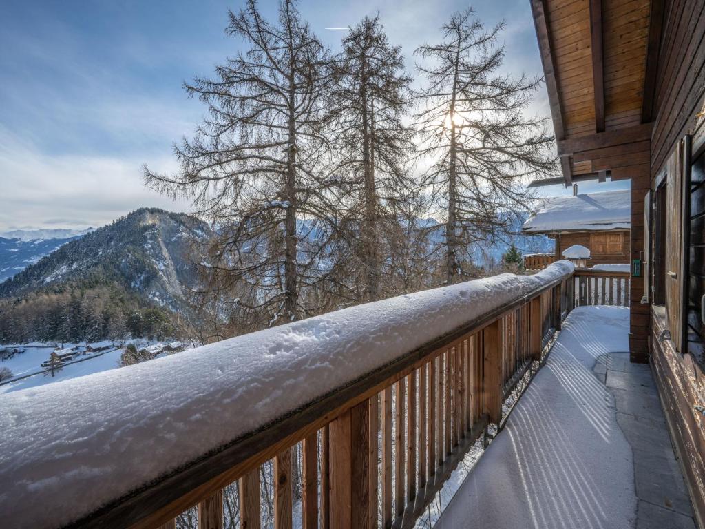a snow covered balcony with a view of the mountains at Chalet Le Sorbier by Interhome in Chamoson
