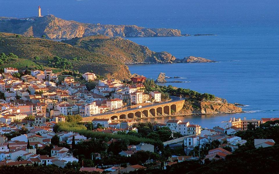 a view of a town with a bridge and the ocean at Face à la mer Résidence Les Elmes in Banyuls-sur-Mer