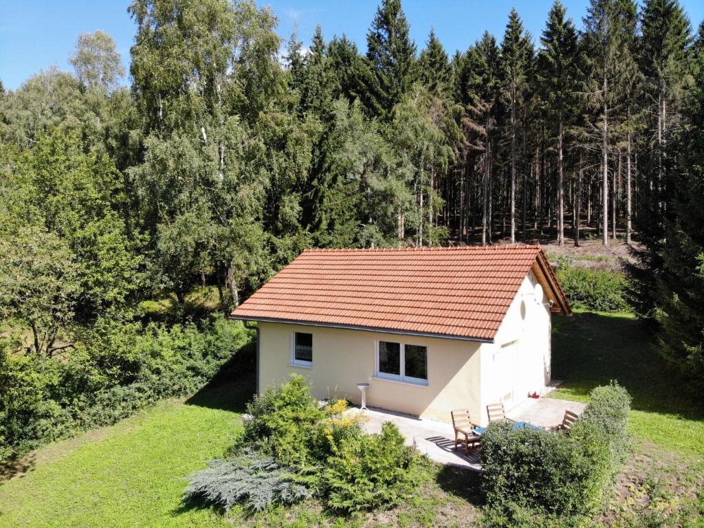 a small white house with a red roof at Holiday Home Konrad by Interhome in Heidersbach