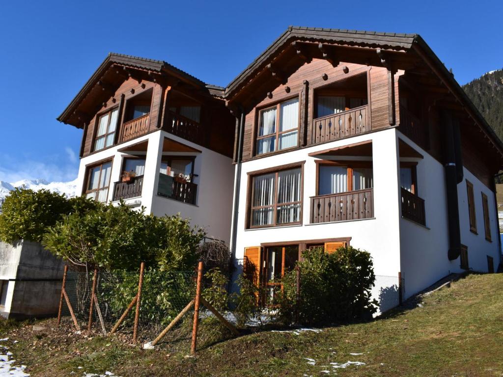 a large building with balconies on top of a hill at Apartment Rüthanet by Interhome in Airolo