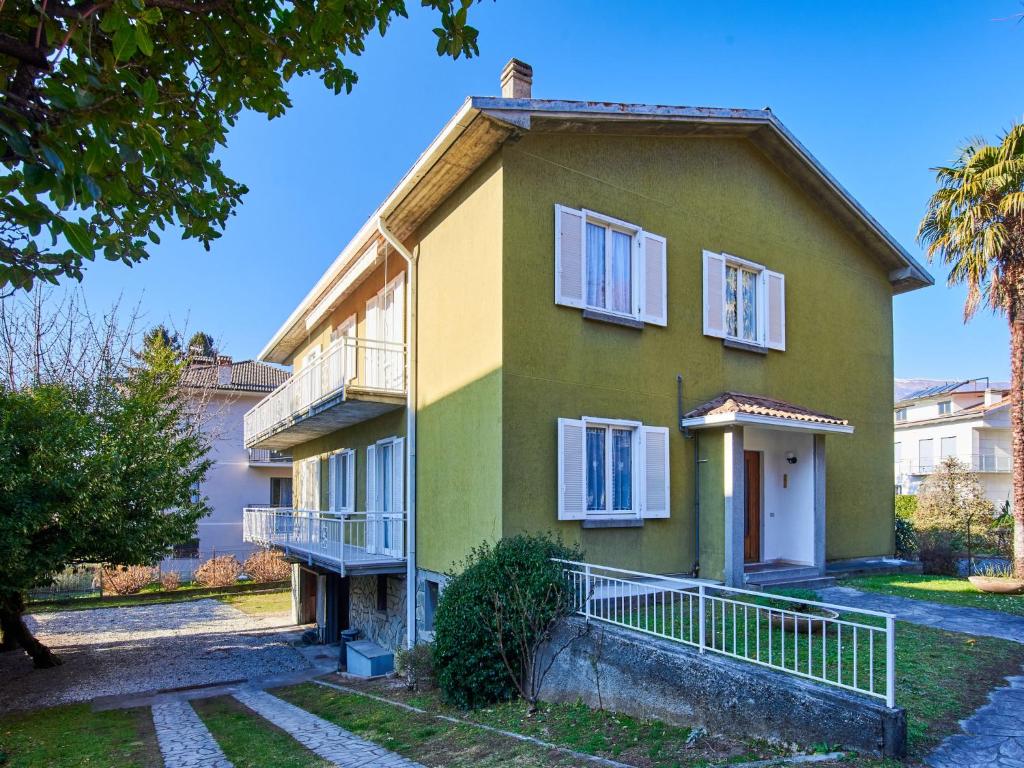 a yellow and green house with a balcony at Apartment Mario by Interhome in Dervio