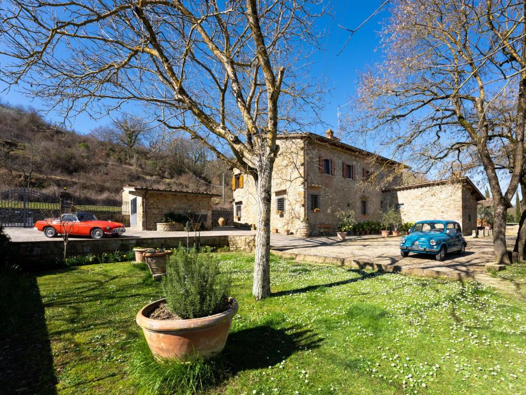 a house with two cars parked in a yard at Holiday Home Casa Mario by Interhome in Greve in Chianti