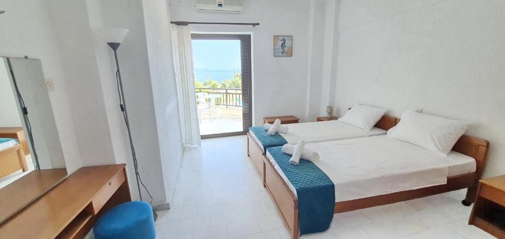 Postel nebo postele na pokoji v ubytování Hotel Pashos