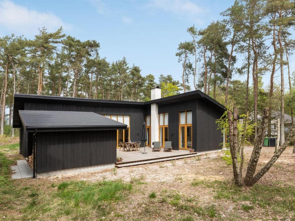 a black house with a black roof at Holiday Home Simona - 800m from the sea in Bornholm in Vester Sømarken