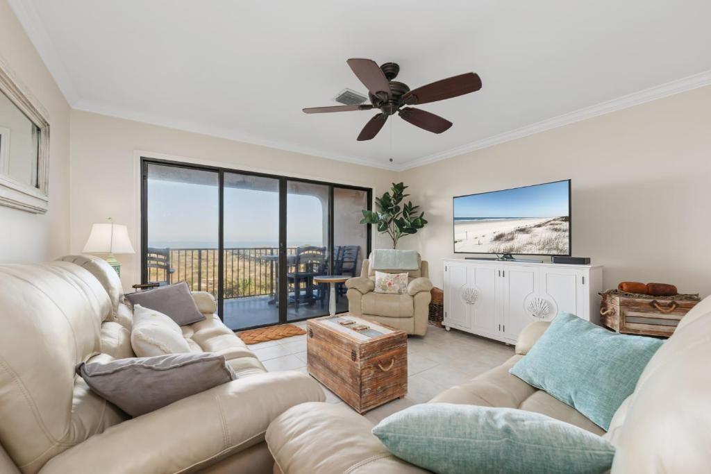 a living room with a couch and a ceiling fan at Sea Place 11211 in Butler Beach