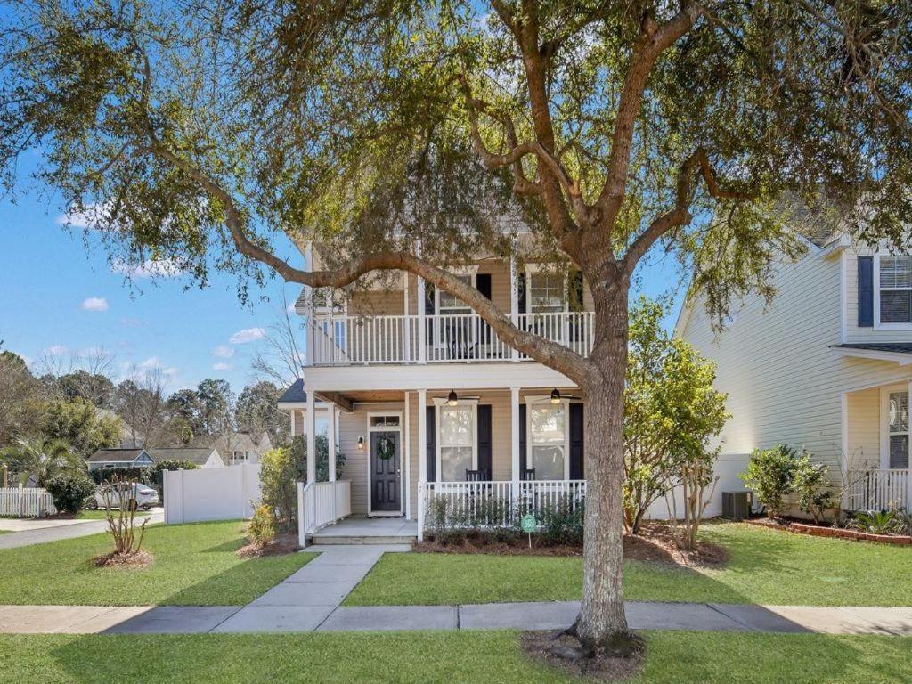 a white house with a tree in front of it at Coastal Quarters in Bluffton