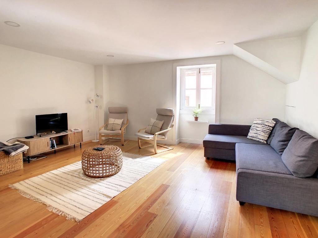 a living room with a couch and a table at FX City Lover by LovelyStay in Funchal