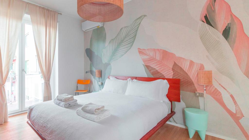 a bedroom with a bed with a tropical mural on the wall at Italianway - Brianza 14 A in Milan