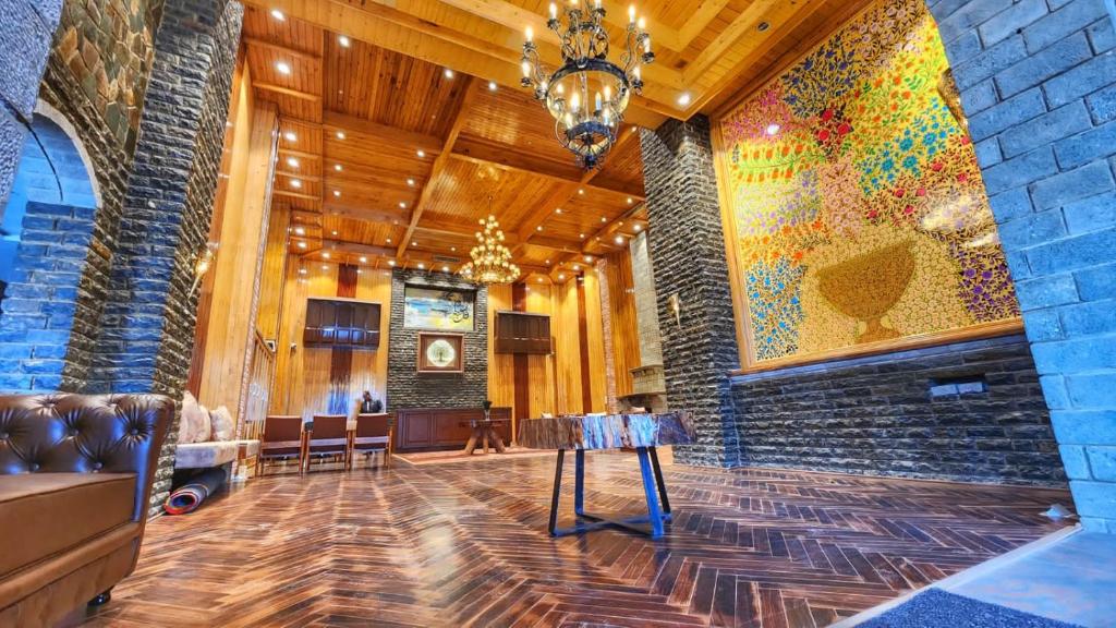 a lobby with a large painting on the wall at The Walnut Creek Pahalgam in Pahalgām