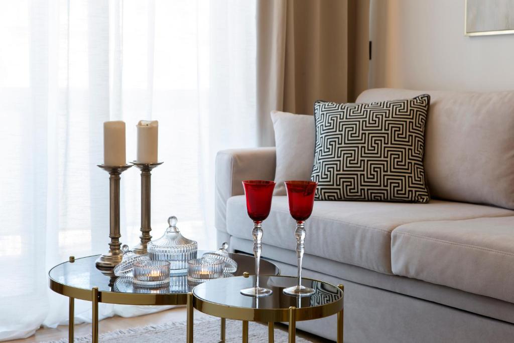 a living room with two red wine glasses on a table at La Residence Athens in Athens