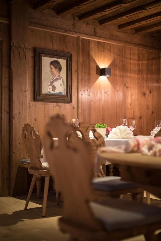 a dining room with a table and a picture on the wall at ElisabethHotel Premium Private Retreat- Adults only in Mayrhofen