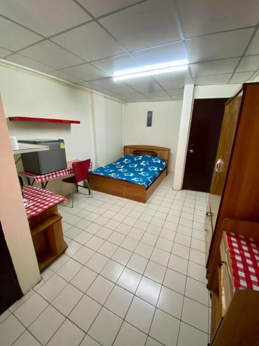 a room with a bed and a table and a desk at Ratanawong Place 552 in Bangkok