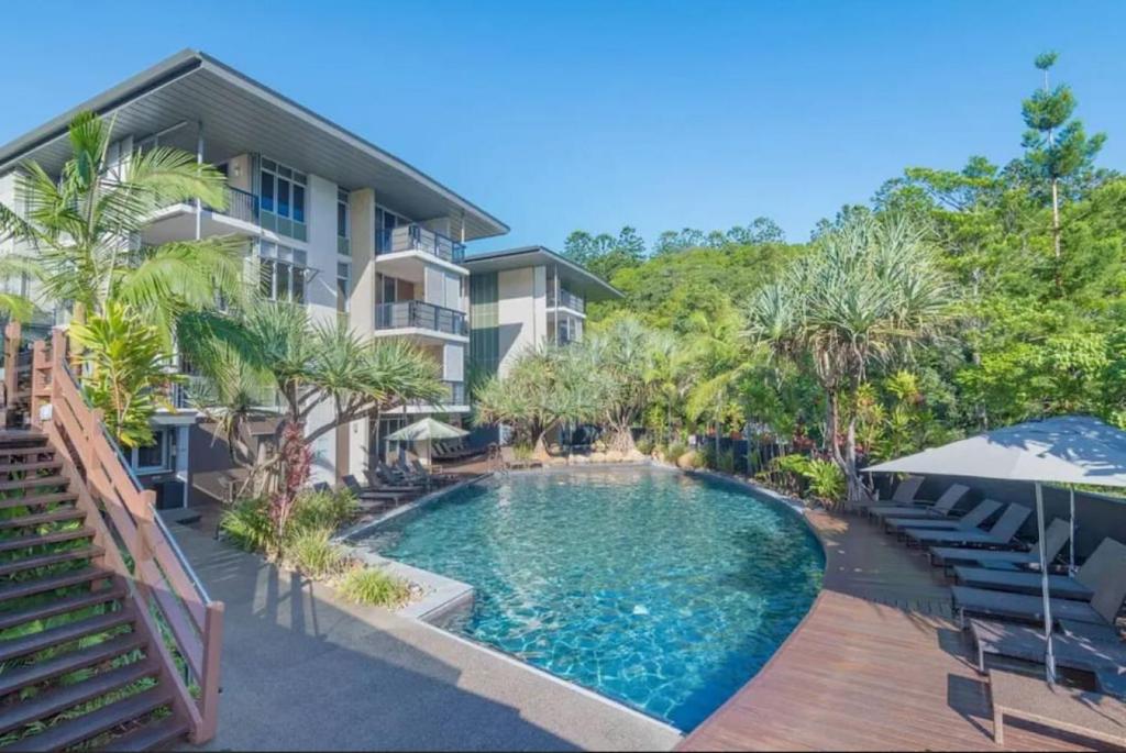 a swimming pool in front of a building at 9311 Fabulous Resort in the Heart of Noosa in Noosa Heads