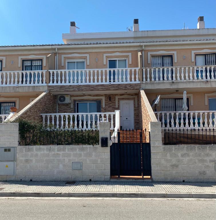 a house with a balcony on top of it at Casa Marta in Beniarjó