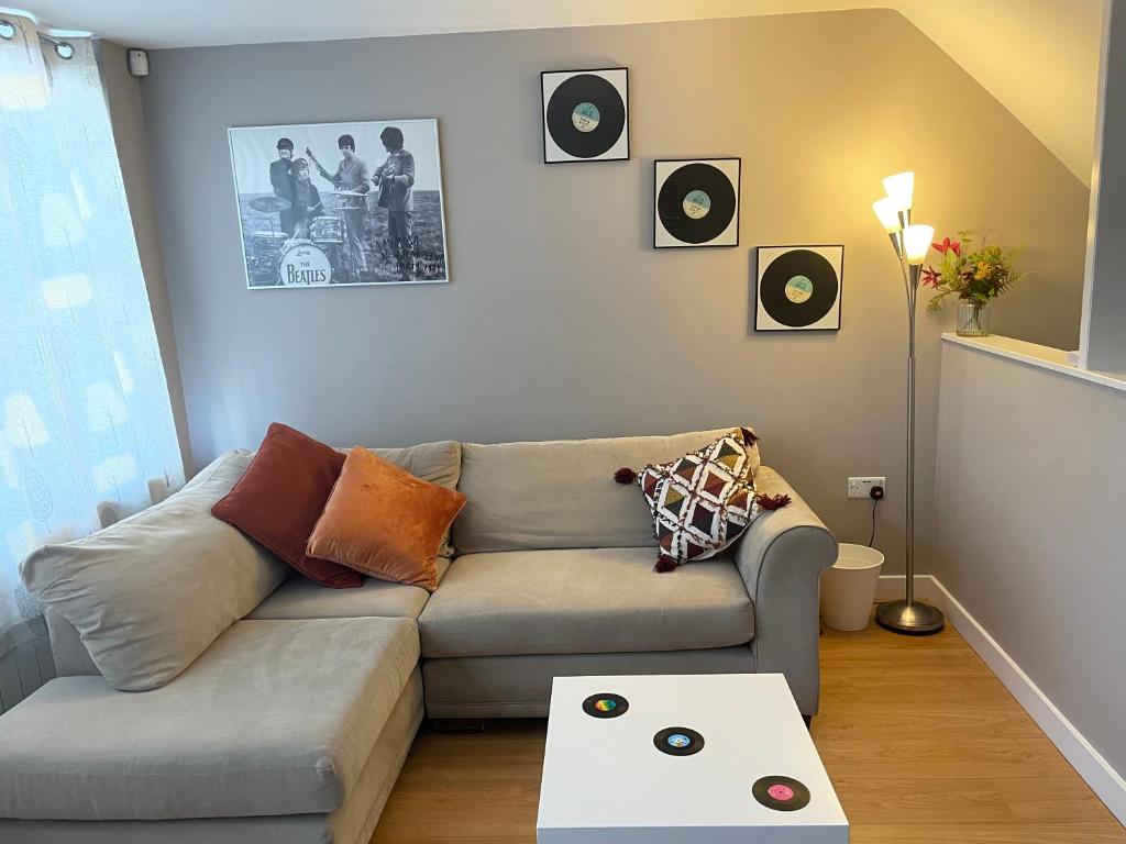a living room with a couch and records on the wall at Hot numbers in Cambridge
