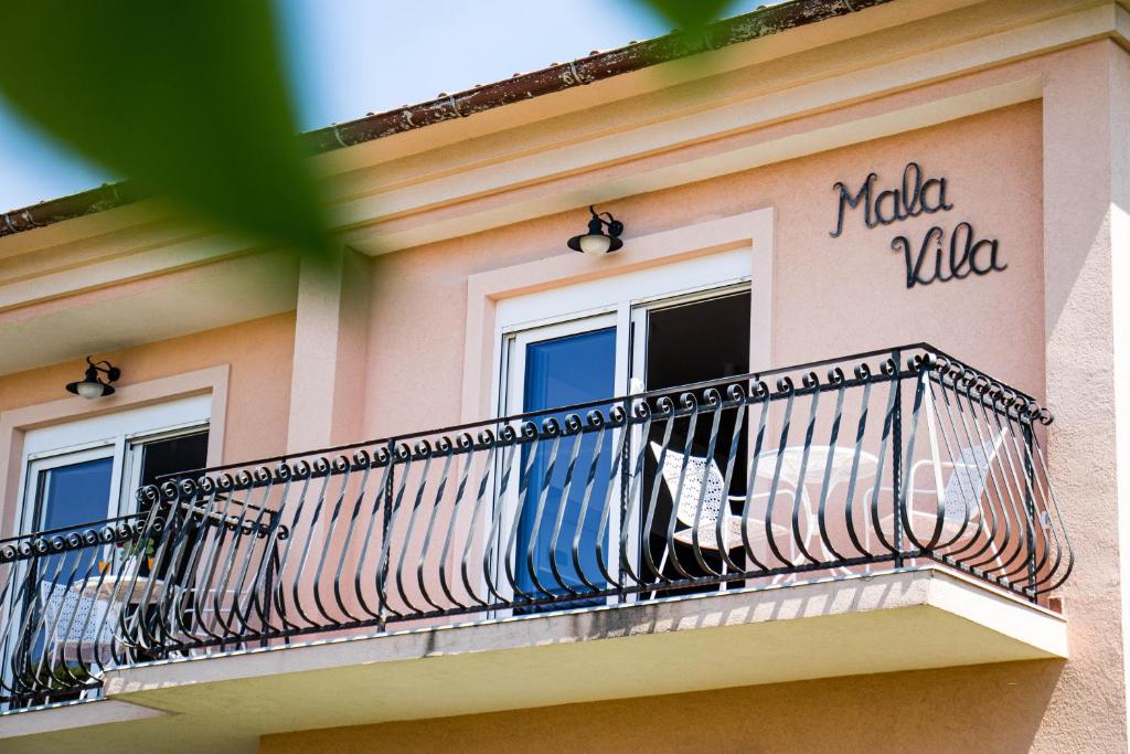 a balcony on the side of a building at Apartments Mala Vila in Rab