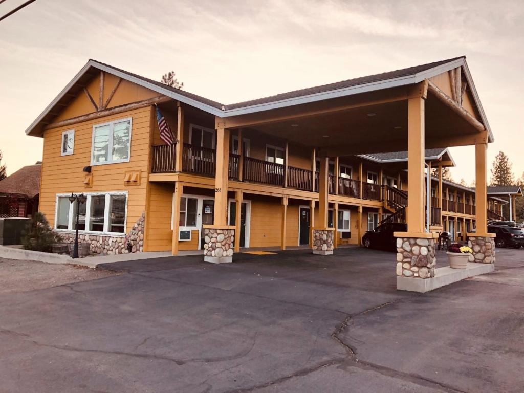 a large apartment building with a parking lot at Antlers Motel in Chester