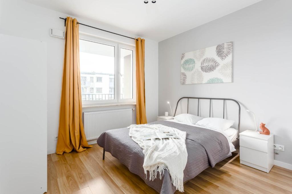 sypialnia z łóżkiem i dużym oknem w obiekcie Chill Apartments Airport Ursynów w Warszawie