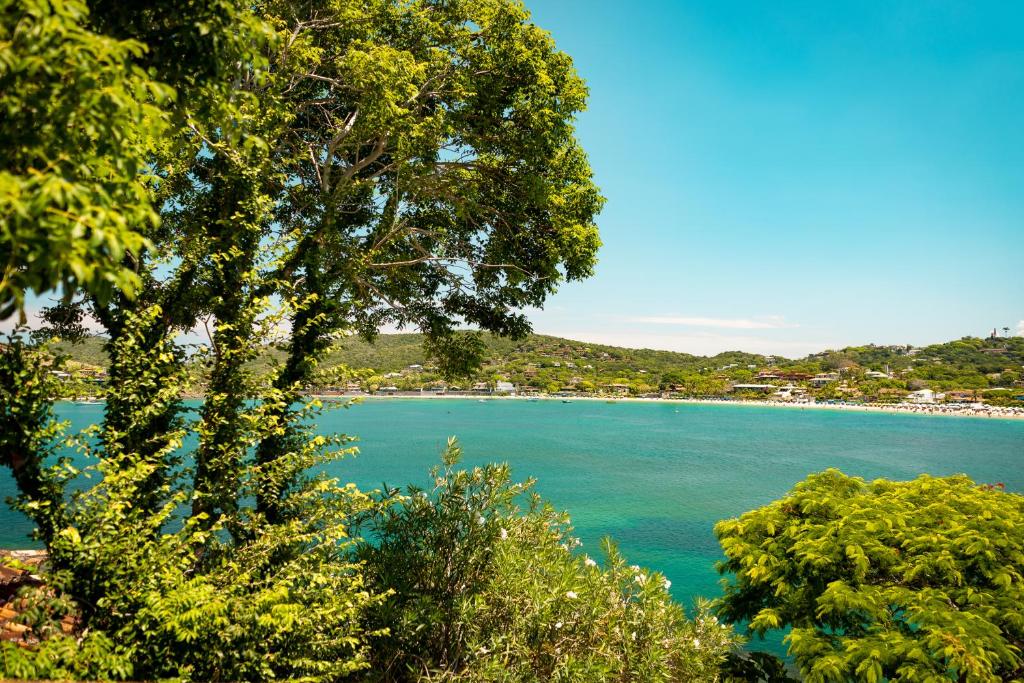 a view of a large body of water with trees at Insólito Boutique Hotel & Spa in Búzios
