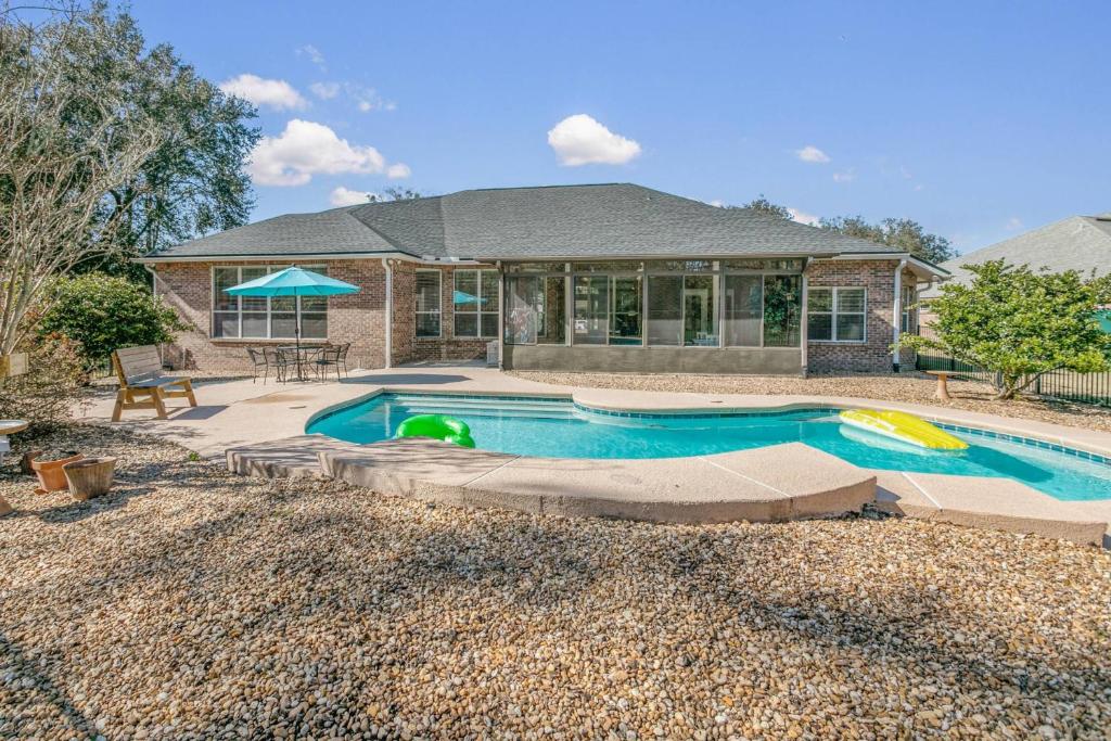 a swimming pool in front of a house at Sunset Pass in Middleburg