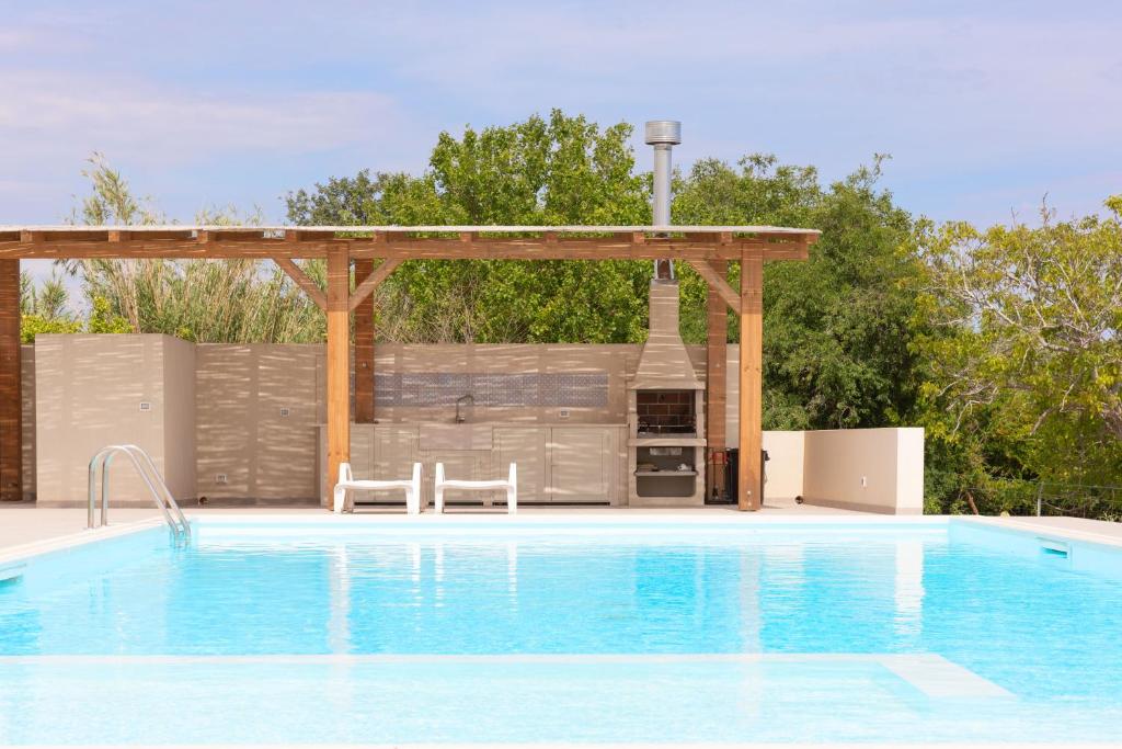 a swimming pool with a pergola next to a swimming pool at emozioni di casa Barone in Scicli