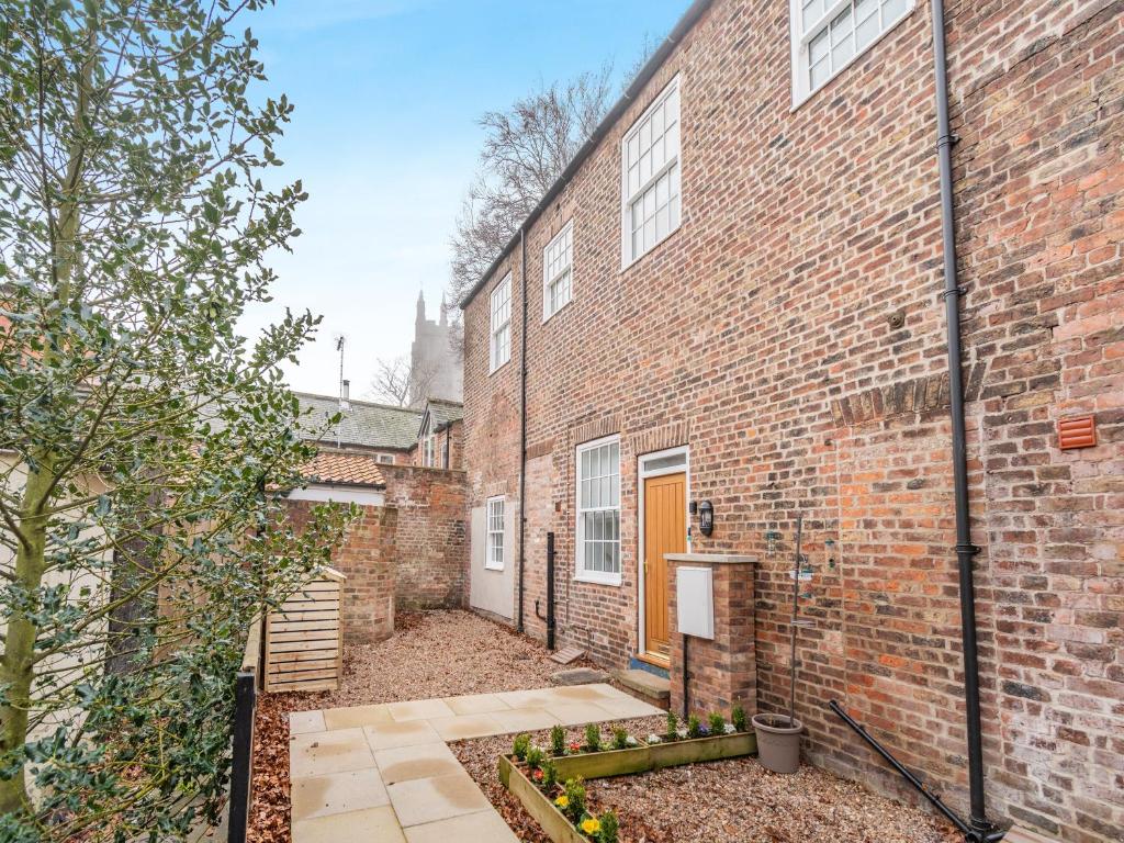 an exterior view of a brick building with a courtyard at The Old Workhouse in Great Driffield