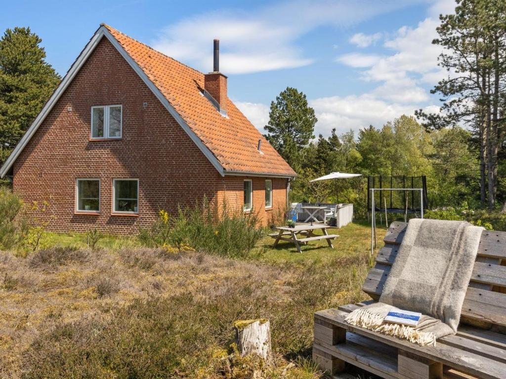 a house with a bench in front of it at Holiday Home Ridir - 3-5km from the sea in Western Jutland by Interhome in Rømø Kirkeby