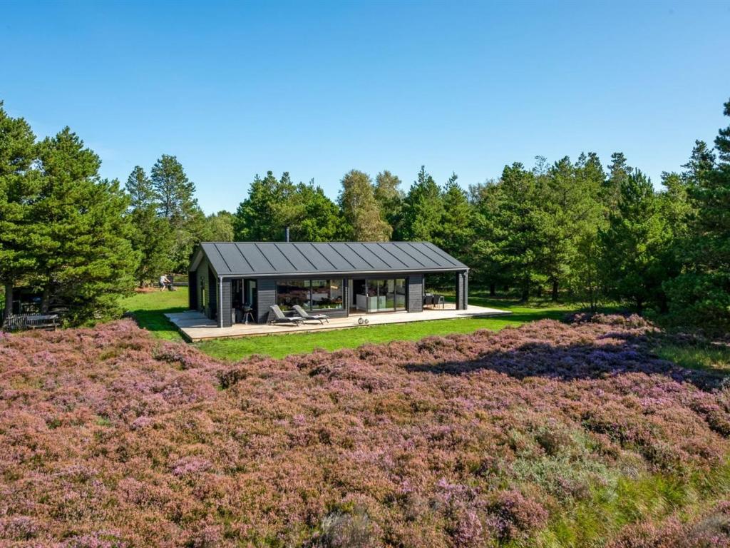 a glass house in the middle of a field at Holiday Home Tea - 2-7km from the sea in Western Jutland by Interhome in Bolilmark