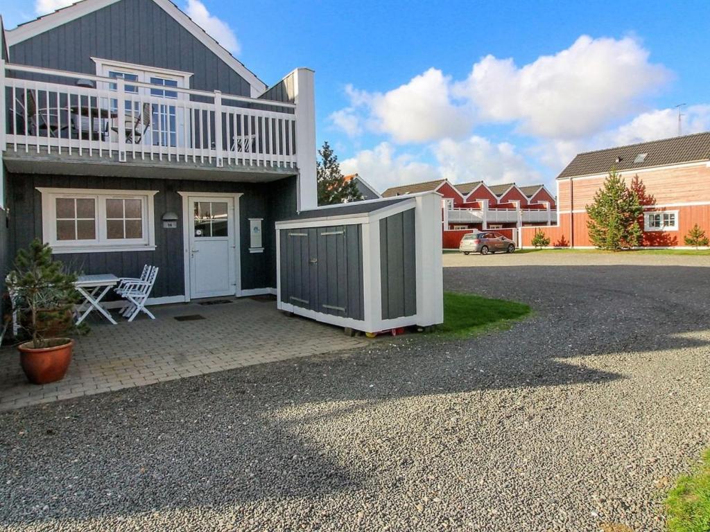 a house with a fence in front of it at Apartment Sote - 1-2km from the sea in Western Jutland by Interhome in Blåvand