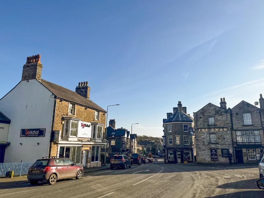 a town with cars parked on a street with buildings at Apartment 2 - Uk42746 in Buxton
