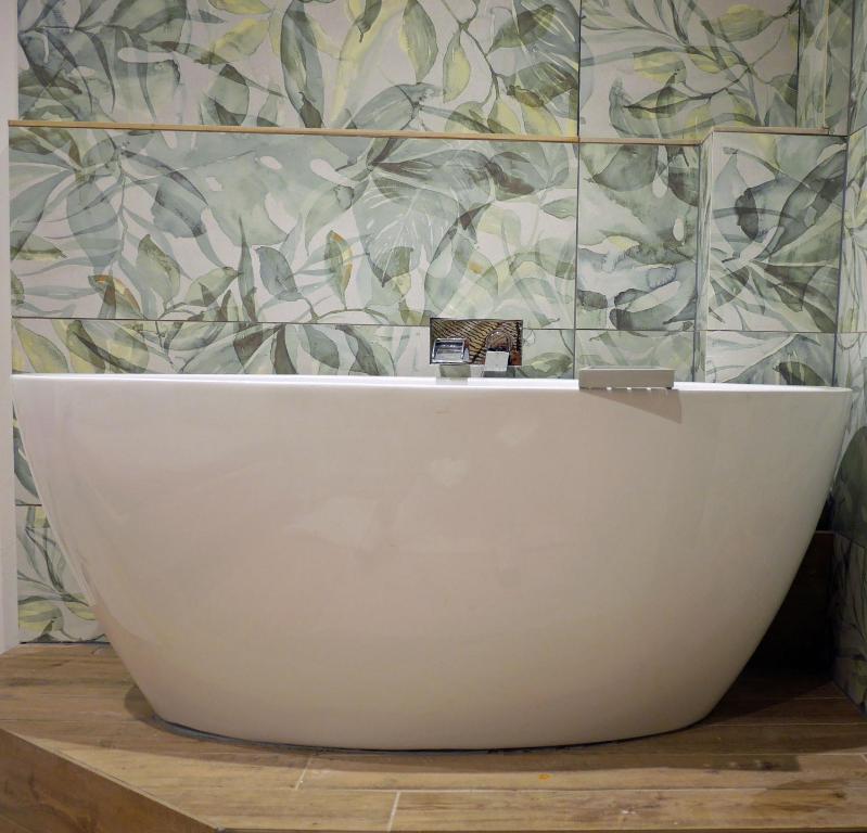 a white bath tub sitting in a bathroom at Folka Rocks in Folkestone