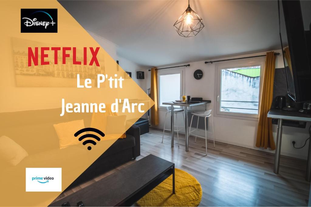 a living room with a couch and a table at Le P'tit Jeanne d'Arc in Nancy