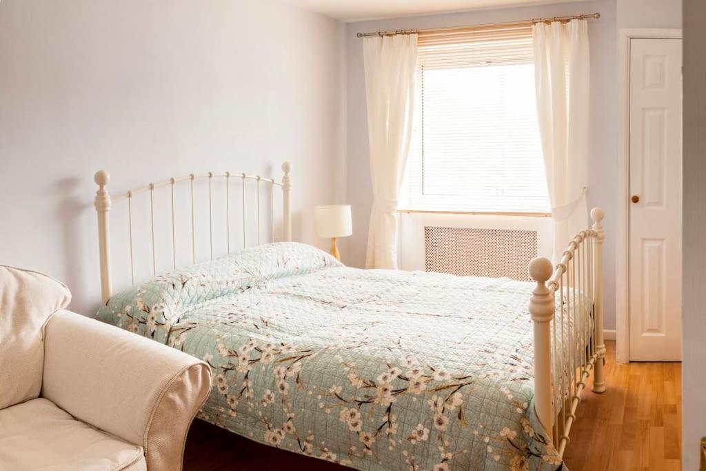 a bedroom with a bed and a couch and a window at Cosy 3 Bed in the heart of Chester in Chester