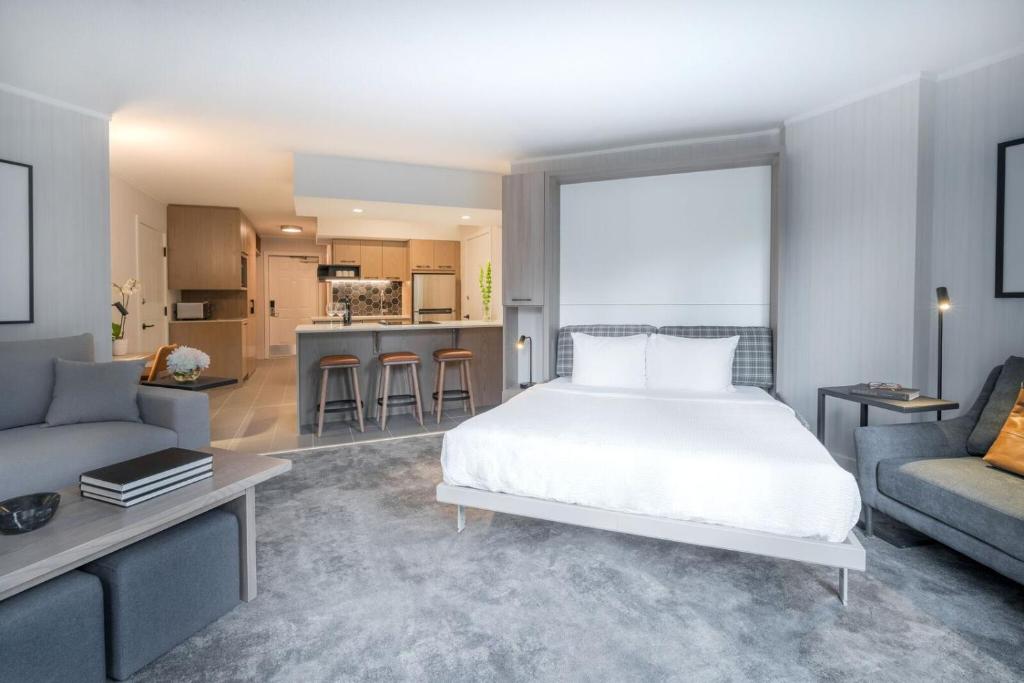 a bedroom with a bed and a living room at Lake Louise Inn in Lake Louise