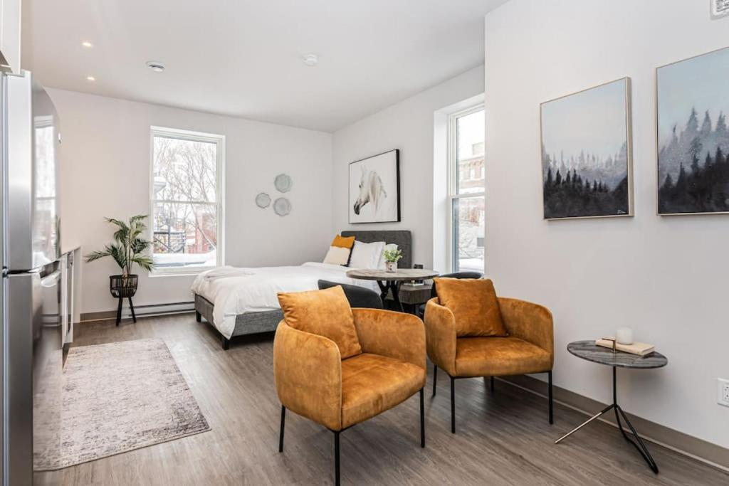 a bedroom with a bed and a table and chairs at Amazing New Apartment Close to Mount Royal Le Plateau by Denstays in Montréal
