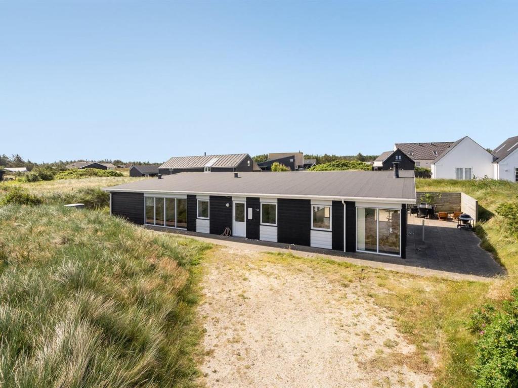uma casa na praia com preto e branco em Holiday Home Julika - 400m from the sea in NW Jutland by Interhome em Torsted