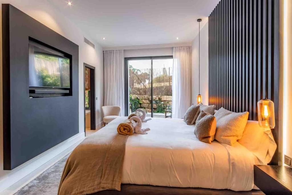 a large bedroom with a large bed and a flat screen tv at Casa Bodhi Boutique Hotel & Spa in Marbella