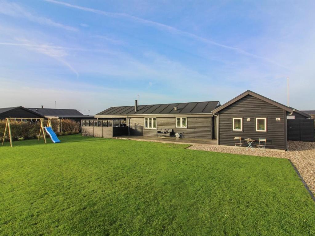 a house with a large yard in front of it at Holiday Home Nehat - 300m from the sea in NW Jutland by Interhome in Løkken