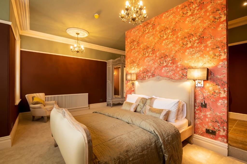 a bedroom with a bed and a large painting on the wall at Harrogate Victorian Luxury in Harrogate
