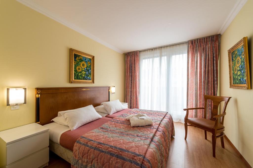 Postel nebo postele na pokoji v ubytování Hotel Churchill