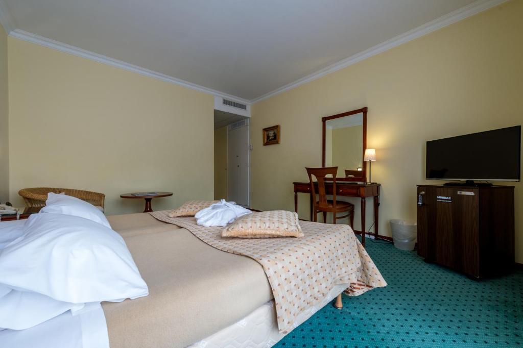 Postel nebo postele na pokoji v ubytování Hotel Churchill
