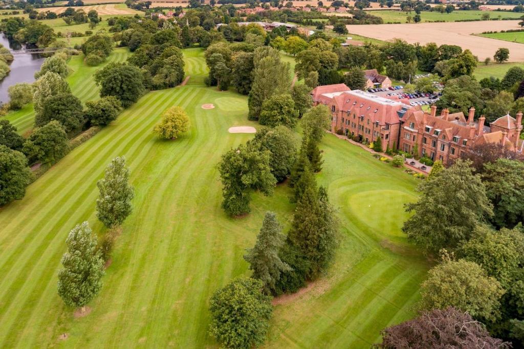 an aerial view of a building on a green field at Aldwark Manor Estate in Aldwark