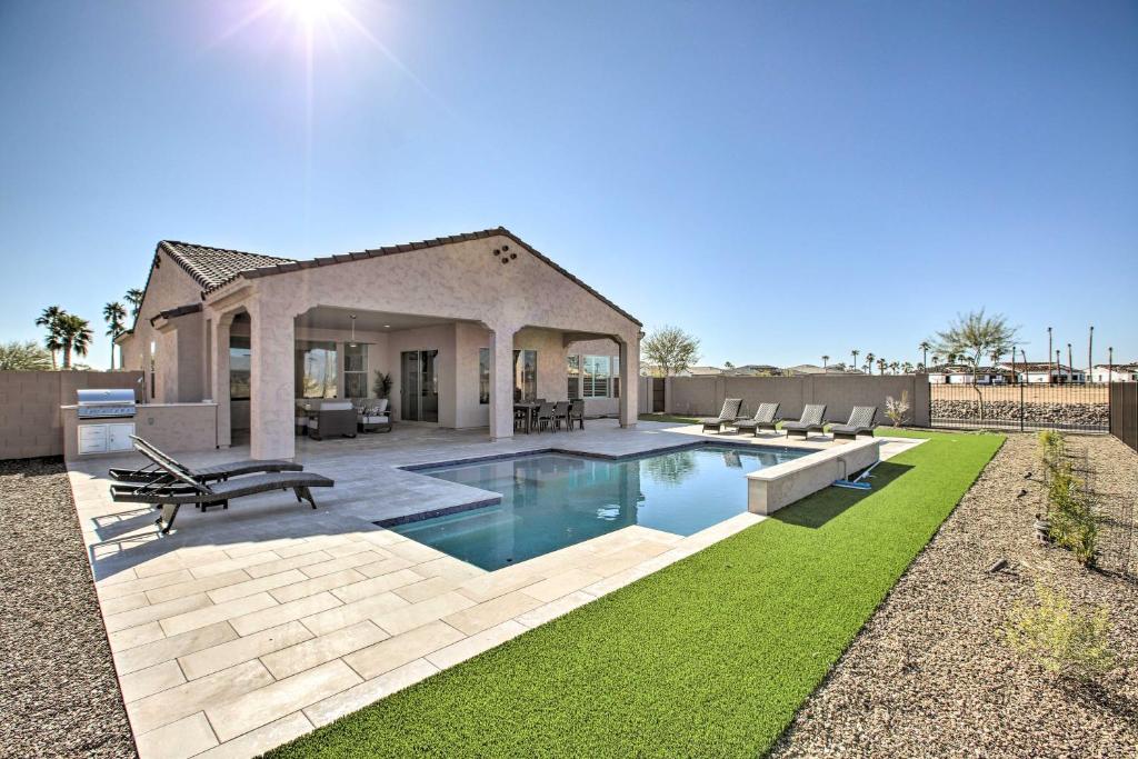 a backyard with a swimming pool and a house at Goodyear Vacation Rental with Private Pool and Grill! in Goodyear